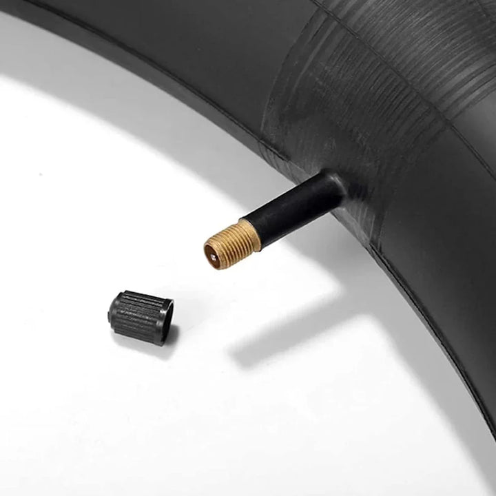 Close-up of CST 20x3.50/4.00 straight Schrader valve with black valve cap for fat tyre tube