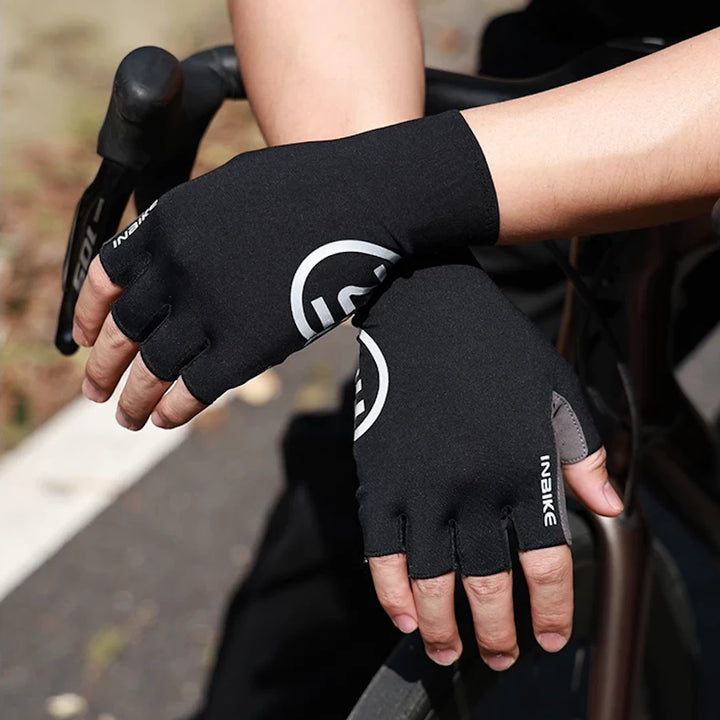 Cyclist wearing INBIKE half-finger gloves on handlebars