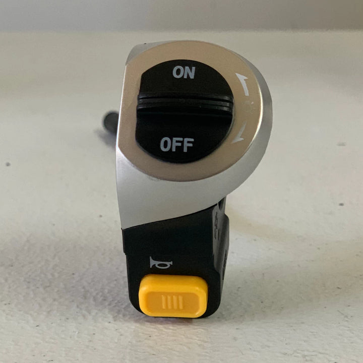 Close-up of the EMOVE Touring light and horn switch featuring easy-to-use controls for toggling the headlight and honking the horn.