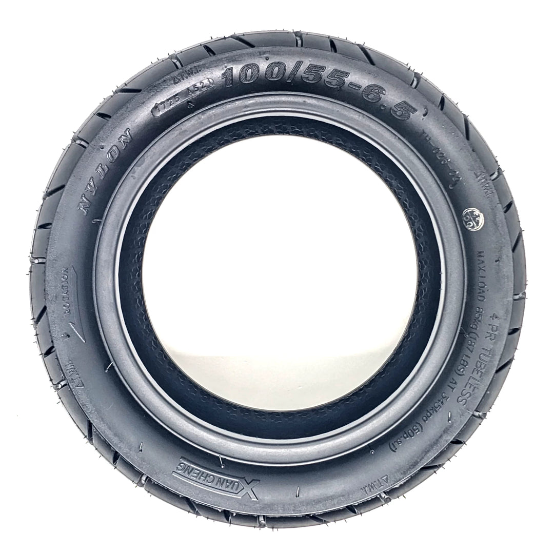 Side profile view of Xuancheng 100/55-6.5 self-healing tubeless tyre showing size, specs and directional arrow to ensure correct installation.