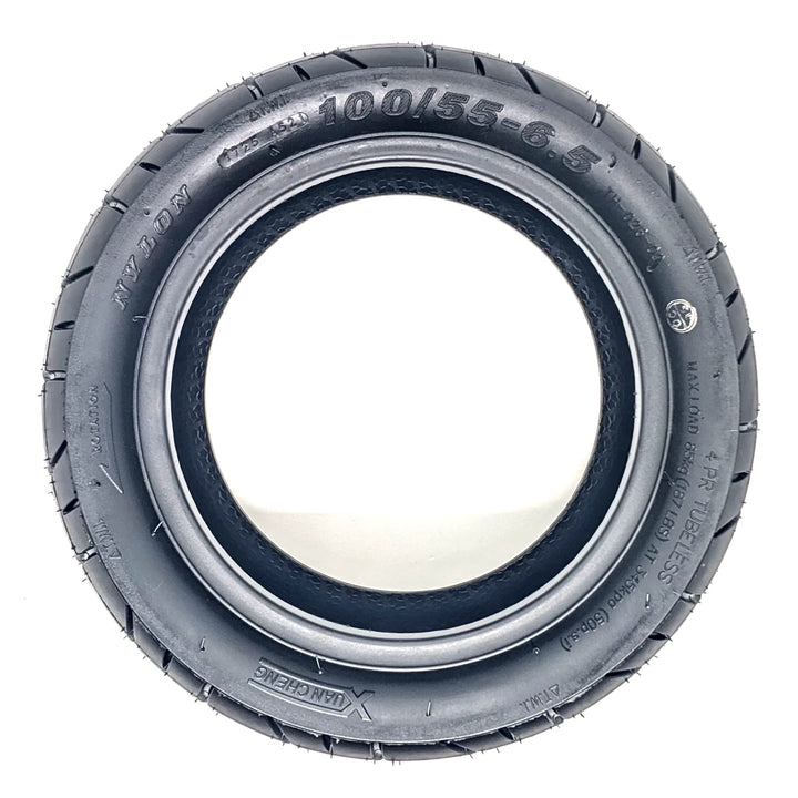 Side profile view of Xuancheng 100/55-6.5 self-healing tubeless tyre showing size, specs and directional arrow to ensure correct installation.