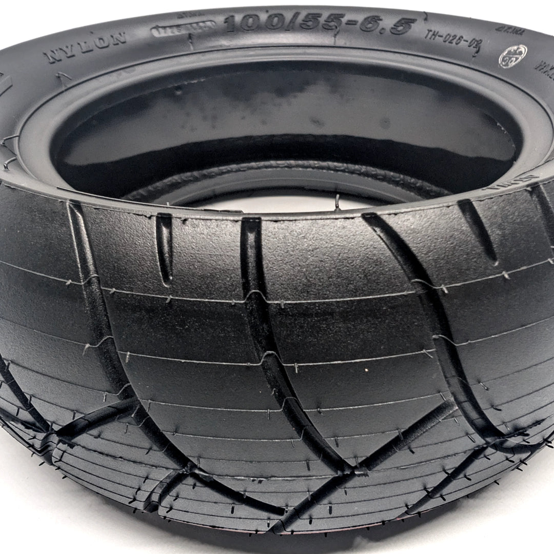 Close up view of the deep tread channels on the Xuancheng 100/55-6.5 self-healing tubeless tyre