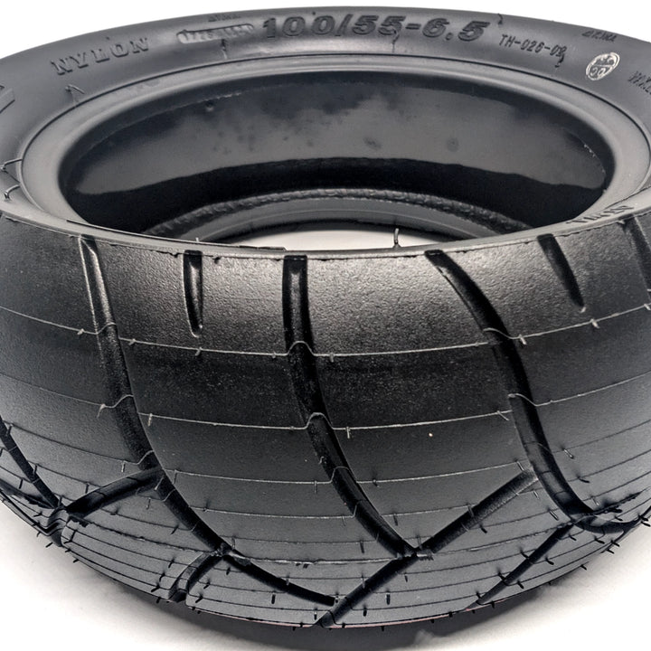 Close up view of the deep tread channels on the Xuancheng 100/55-6.5 self-healing tubeless tyre