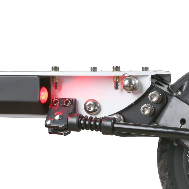 Rear deck of the EMOVE Touring electric scooter with brake light illuminated, showcasing safety features.