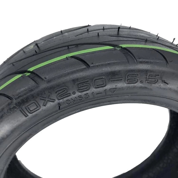 Detailed view of the CST 10x2.50-6.5 Tubeless Tyre sidewall with sizing and deep tread grooves.