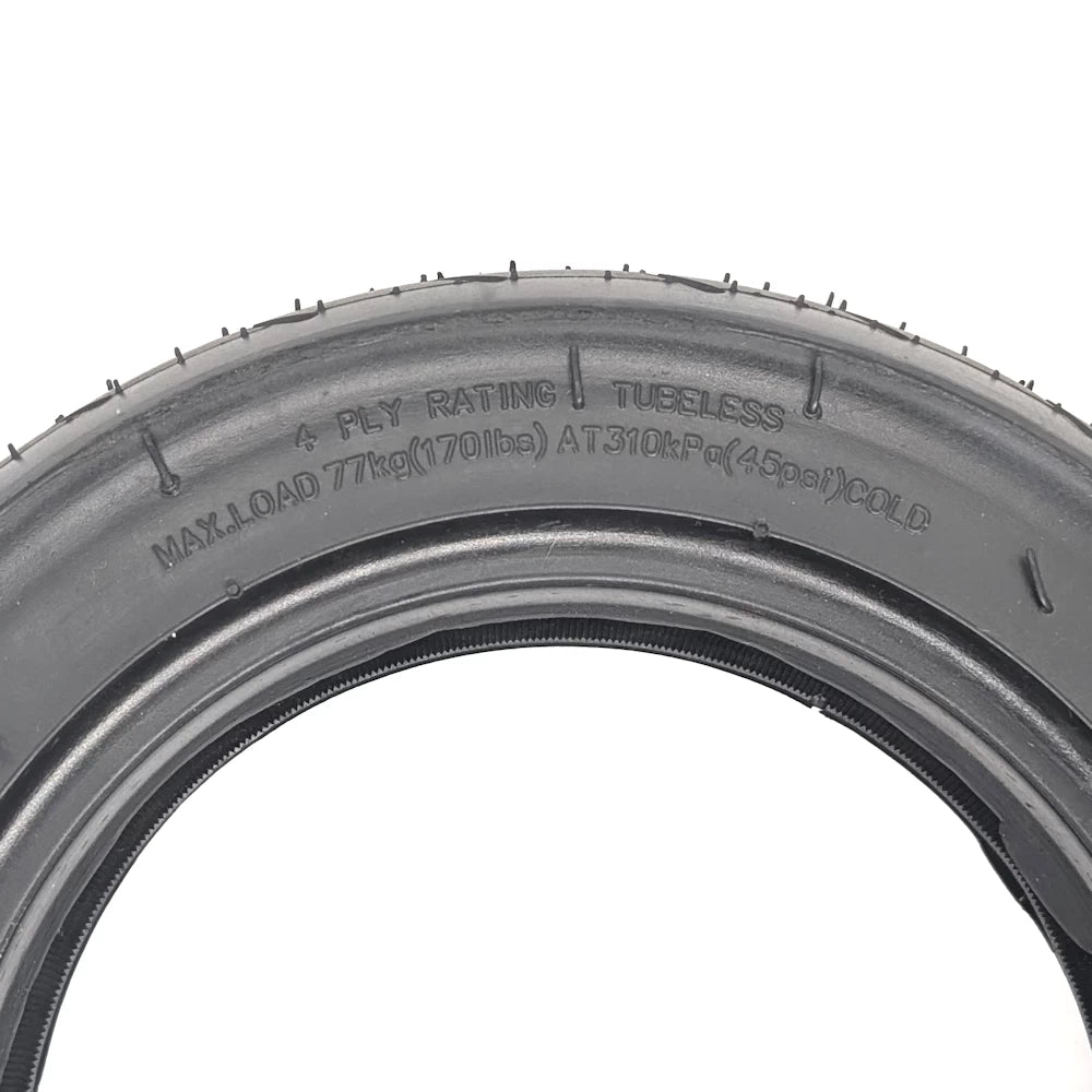Detail showing “Tubeless” and “4-Ply Rating” sidewall text.