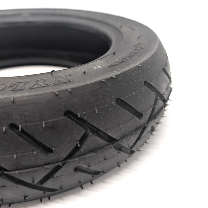 Close tread detail showing cross-pattern grooves and durable rubber surface.