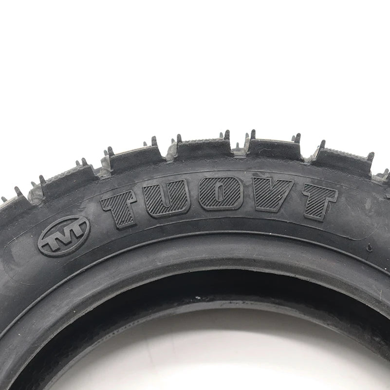 TUOVT 255x80 all-terrain tyre for electric scooters, providing superior traction and durability on diverse surfaces for enhanced off-road performance. The TUOVT brand imprint is displayed on the side wall of the tyre