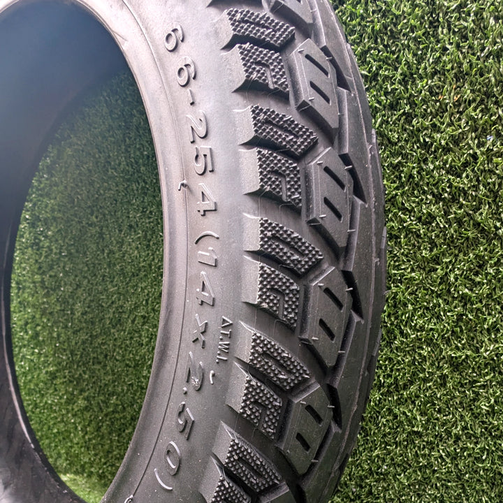 Angled view of ULIP MANLUNG 14x2.50 tubeless hybrid electric scooter tyre, showing the stippled shoulder tread