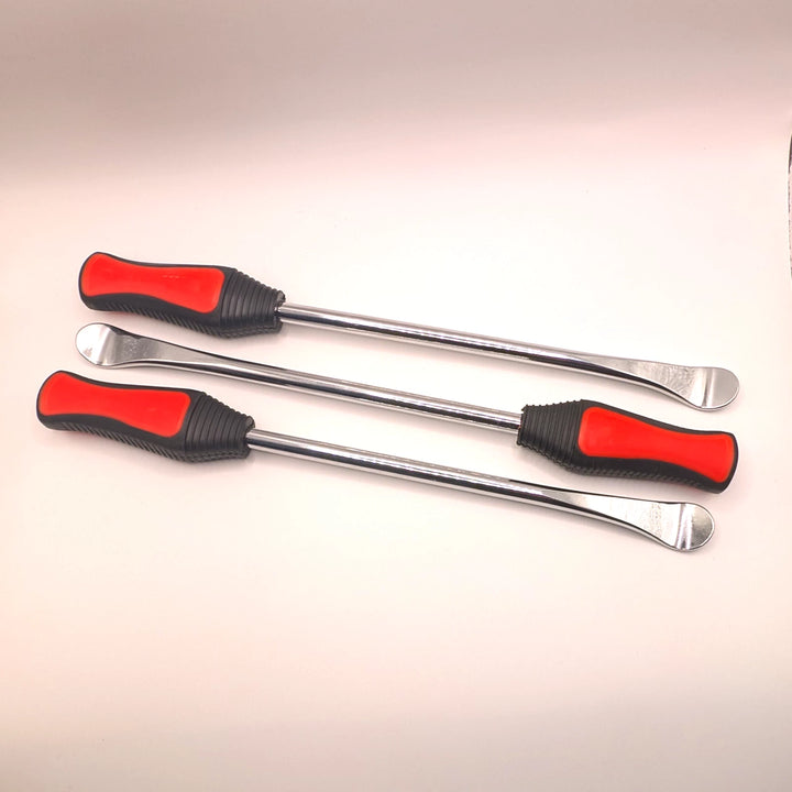 Three metal tyre levers laid in alternating directions, showing spoon-shaped ends and textured handles