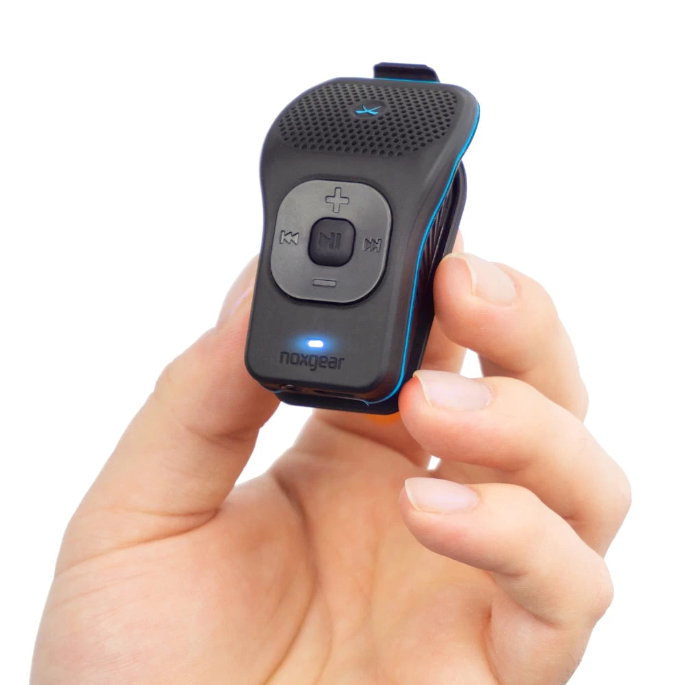 NoxGear 39g wearable Bluetooth speaker held in hand, showcasing its lightweight design and compact size.