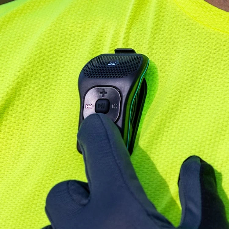 NoxGear 39g Bluetooth speaker being used with gloves, demonstrating its large, glove-friendly control buttons.