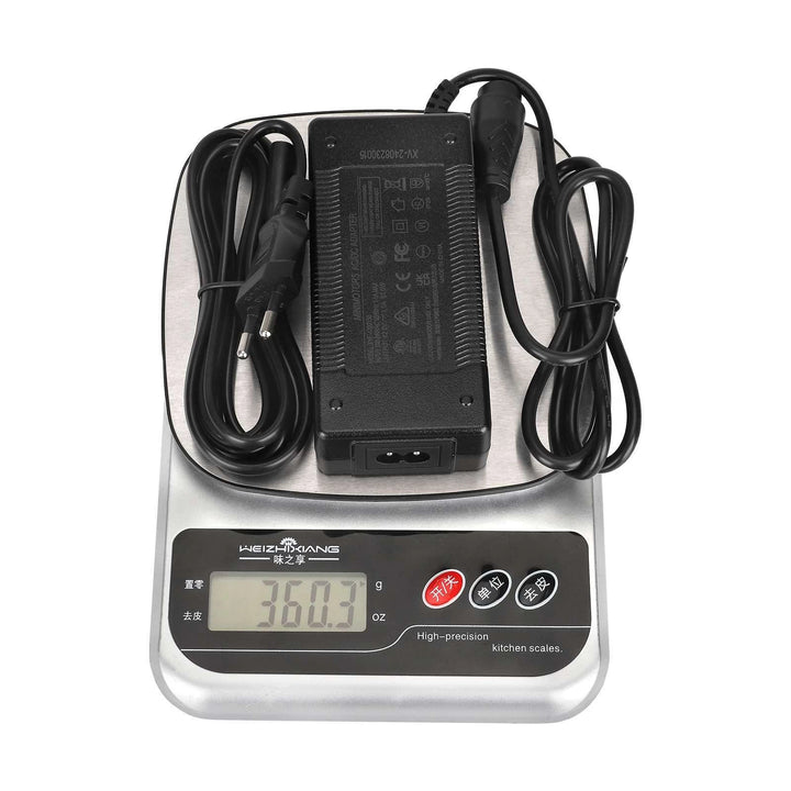 Original Minimotors 42V 1.5A charger for Dualtron TOGO shown on scales weighing approximately 360g.