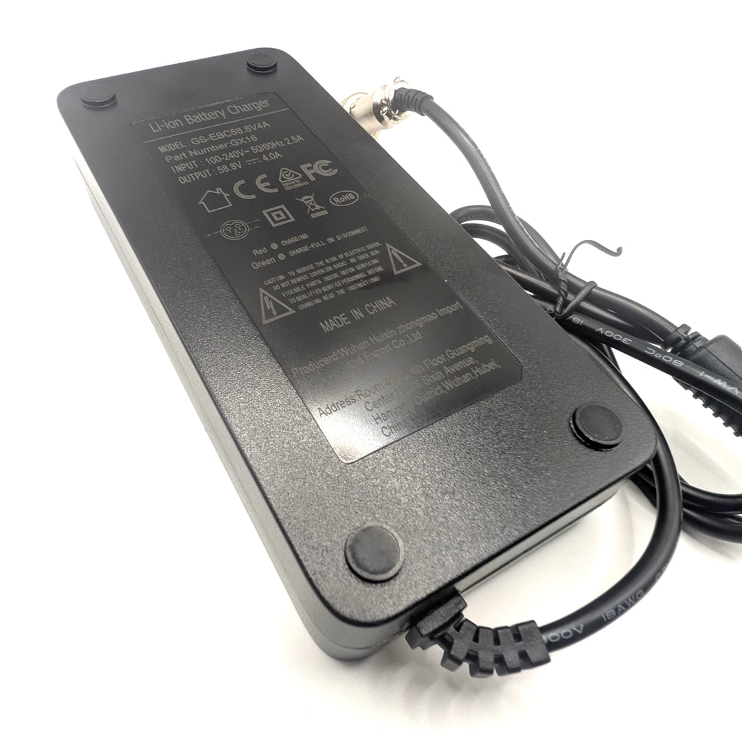 Angled underside view of the black fast charger showing its label, support feet and cable outlet.