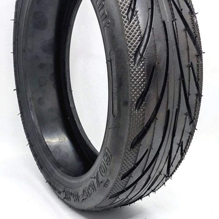 Close up hero view of the genuine Ninebot 60/65-6.9 Self-Healing rear tyre for the Ninebot MAX G2 and G65, showing directional tread and self-healing glue layer inside.