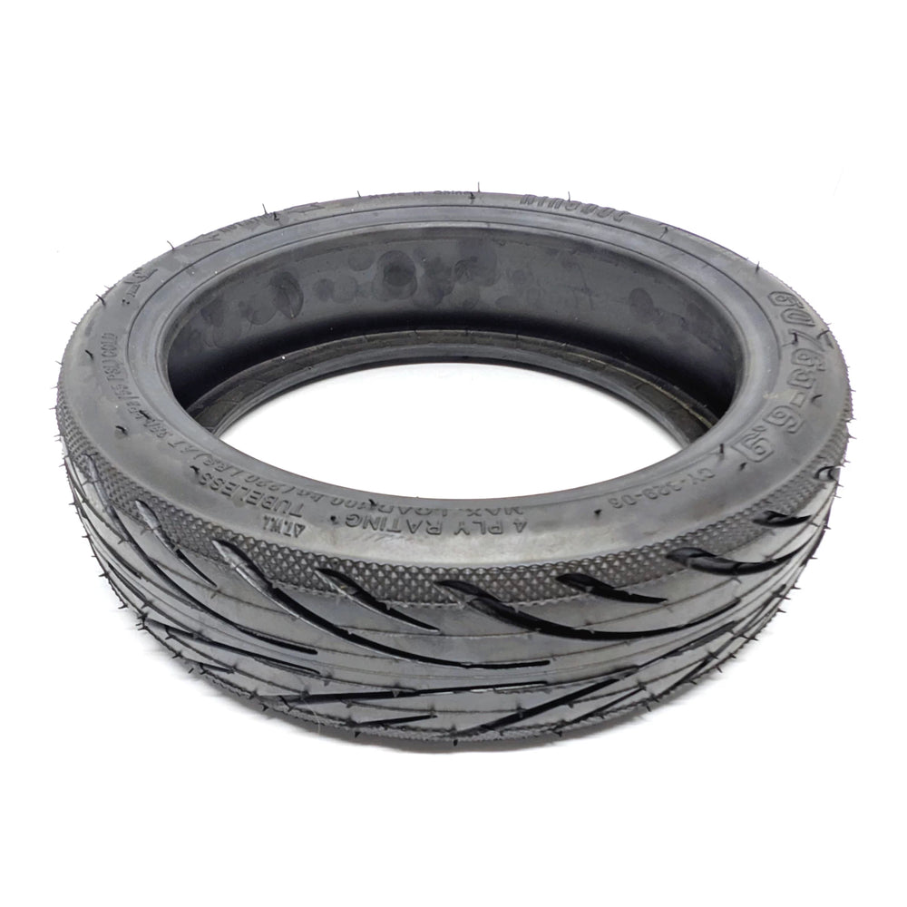 Laid flat, low angle view of the genuine Ninebot 60/65-6.9 Self-Healing rear tyre. OEM replacement rear tyre for Ninebot MAX G2 and G65.