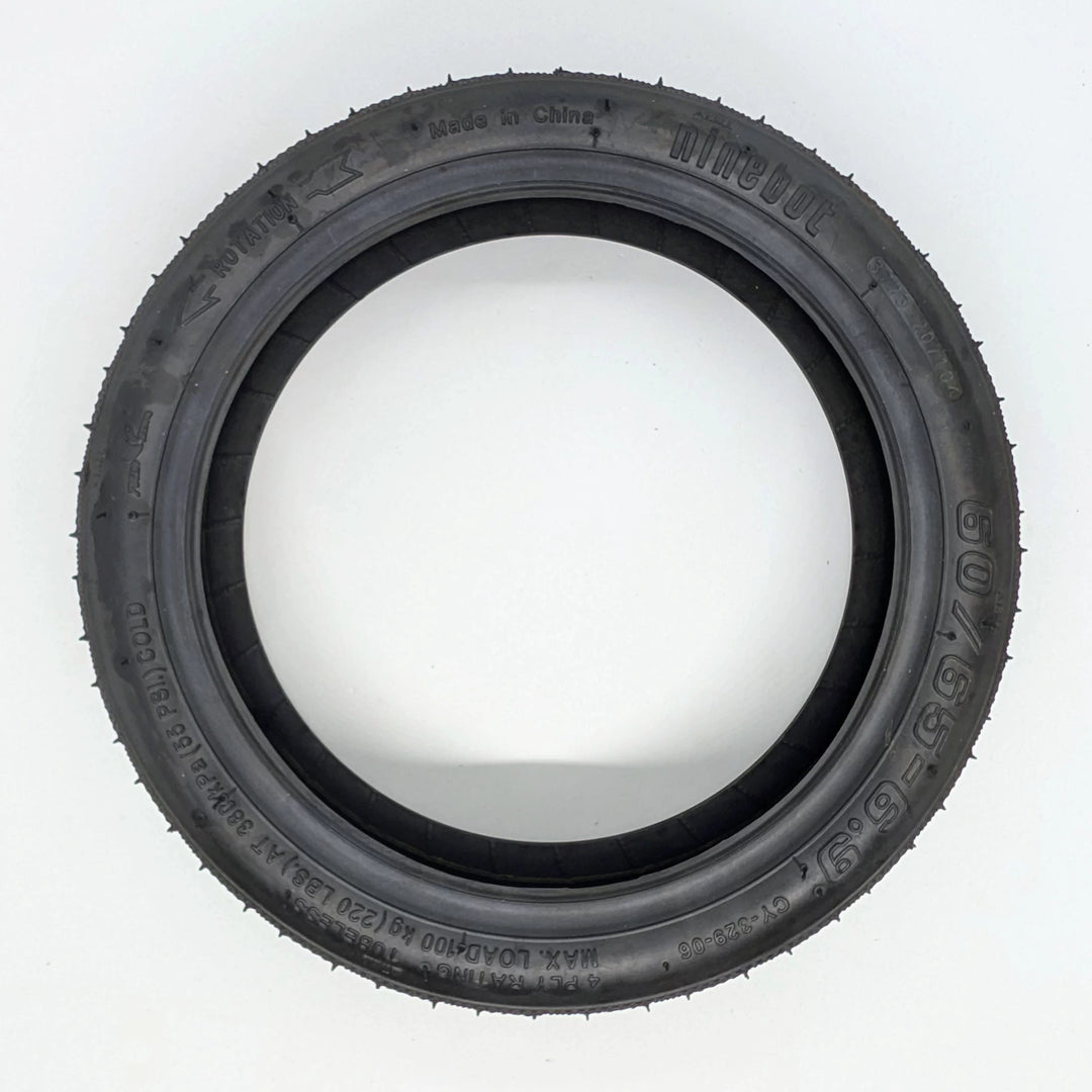 Side profile view of the genuine Ninebot Self-Healing tyre, showing Ninebot brand, 60/65-6.9 sizing and directional arrow on sidewall.  