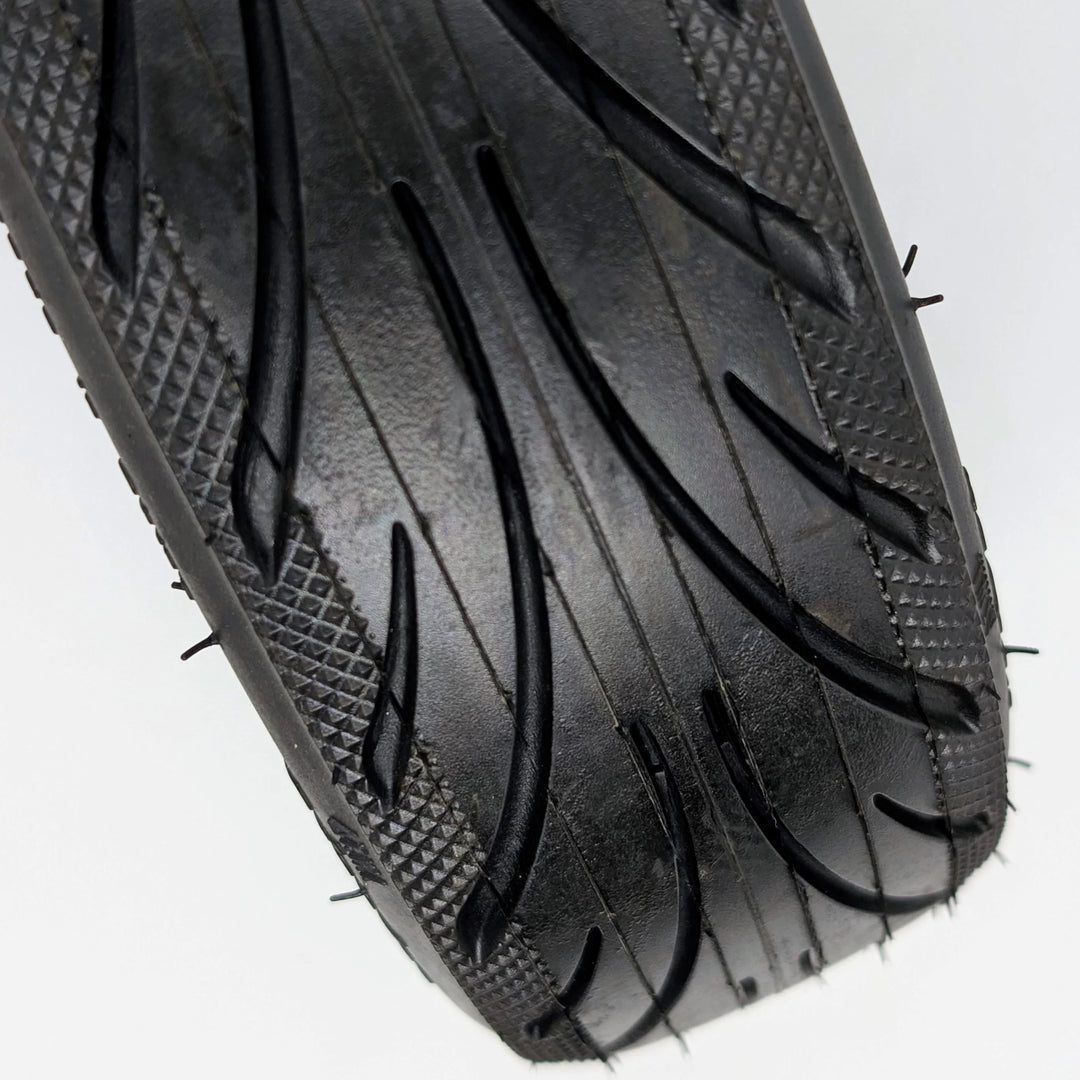 Close-up view of the directional tread pattern and diamond-stipple shoulder of the genuine Ninebot 60/65-6.9 Self-Healing rear tyre for the Ninebot MAX G2 and G65