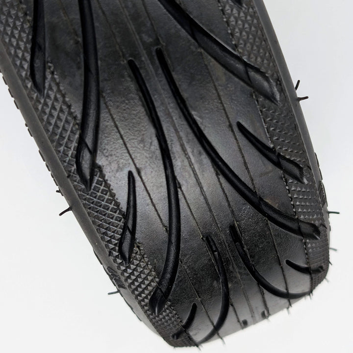 Close-up view of the directional tread pattern and diamond-stipple shoulder of the genuine Ninebot 60/65-6.9 Self-Healing rear tyre for the Ninebot MAX G2 and G65