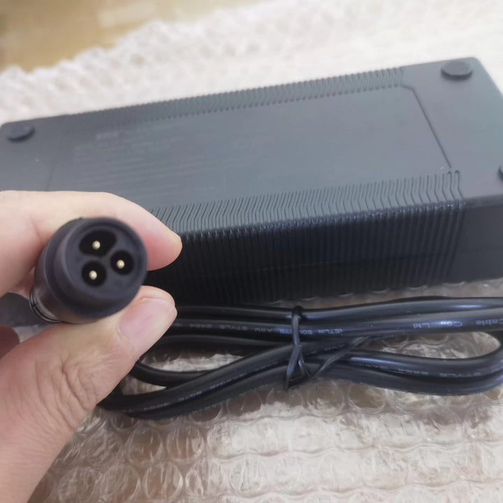 Close up view of the Baming plug on the 66.4V 1.75A charger for 60V Dualtron electric scooters