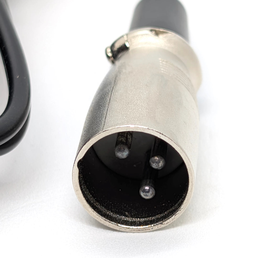 Close-up of 3-pin male XLR plug on 67.2V electric scooter charger