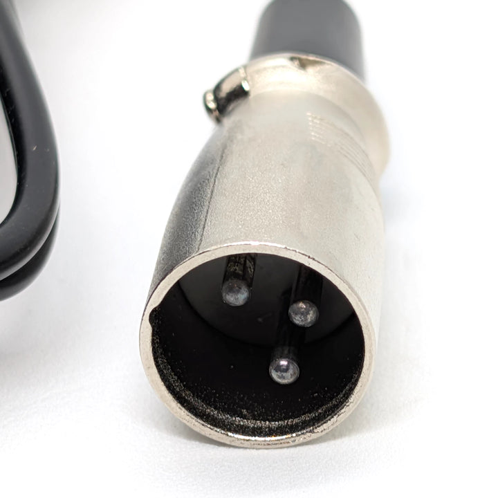 Close-up of 3-pin male XLR plug on 67.2V electric scooter charger
