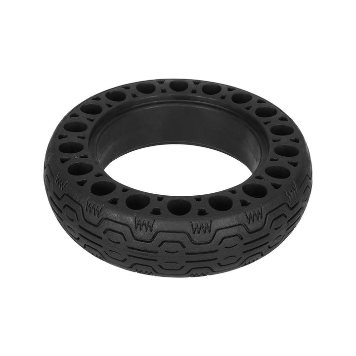 Solid honeycomb tyre lying flat, showing the tread pattern and inner mounting surface