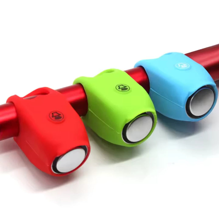 red, blue, and green bells mounted on bike handlebars.