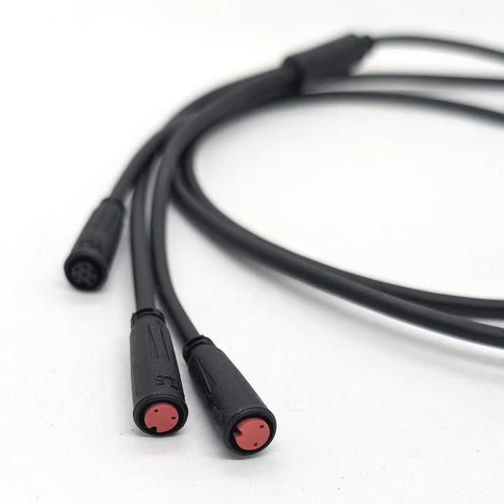 Close-up focus of the two, red-2-pin female waterproof plugs on the 3-to-1 replacement cable/wiring harness for the Bexly Raven electric scooter.