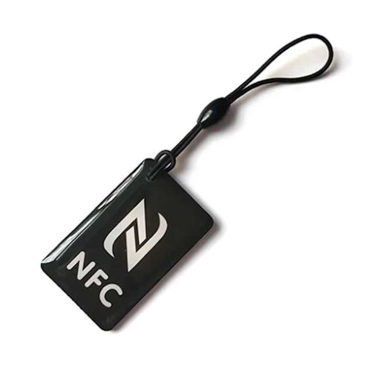 Black, rectangular (50mm x 30mm) NFC tag token with rope, compatible with NFC-enabled devices, designed for electric scooter protection and access control.