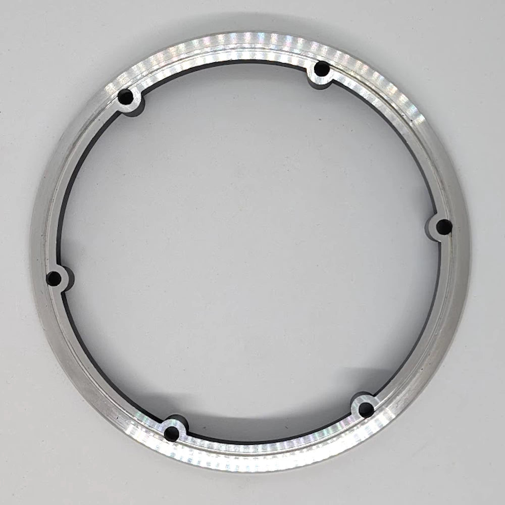 Underside view of aluminium motor ring showing tyre bead seating surface