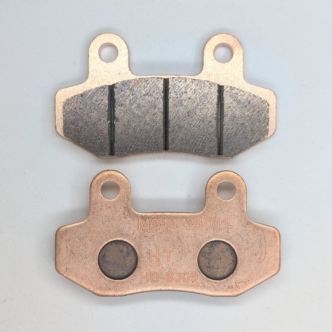 Surron Ultra Bee copper-based sintered brake pads showing the friction face and backing plate