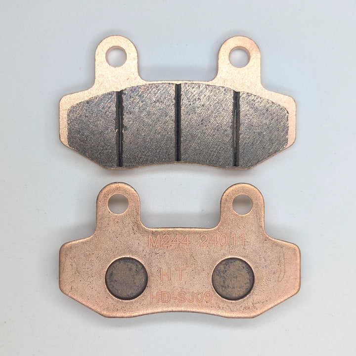 Surron Ultra Bee copper-based sintered brake pads showing the friction face and backing plate