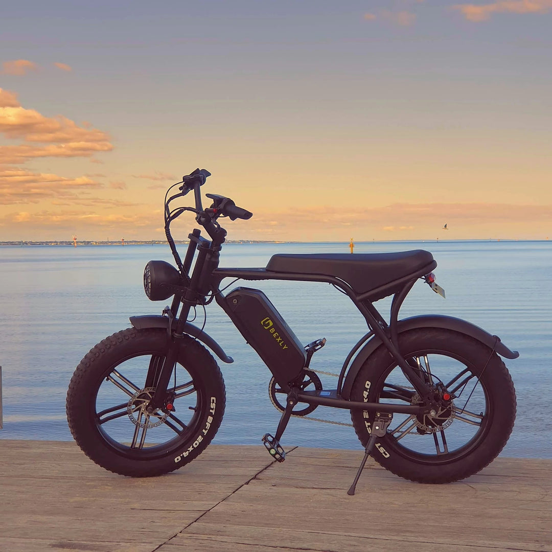 Bexly Brixton electric bike parked at the water's edge in Port Melbourne at dusk, showcasing stylish design and fat tire versatility for urban and off-road adventures. (Image Copyright EcoMotion)