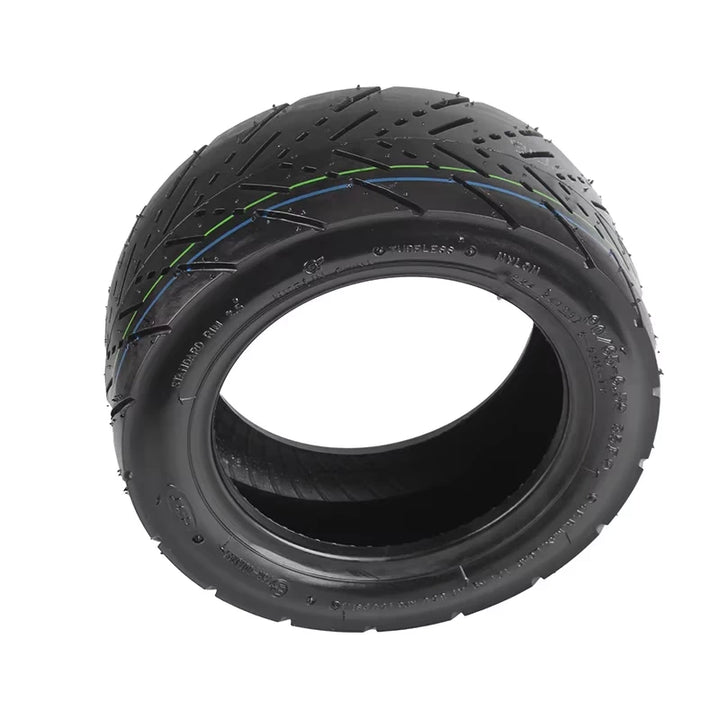 Top-down profile of CST 11 inch self-healing road tyre with green and blue centre lines and visible internal puncture-protection layer.
