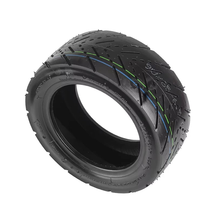 Hero shot of CST 90/65-6.5 self-healing road tyre for electric scooters, showcasing sidewall branding, aggressive road tread, and sealing layer inside.