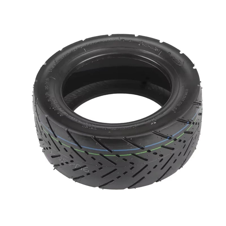 Flat lay image of CST self-healing tubeless tyre with detailed view of tread grooves and internal sealing compound for automatic puncture repair.