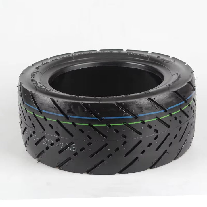 Angled side view of CST 90/65-6.5 self-healing road tyre showing dual-colour centre lines, tread pattern, and visible inner puncture-sealing liner.
