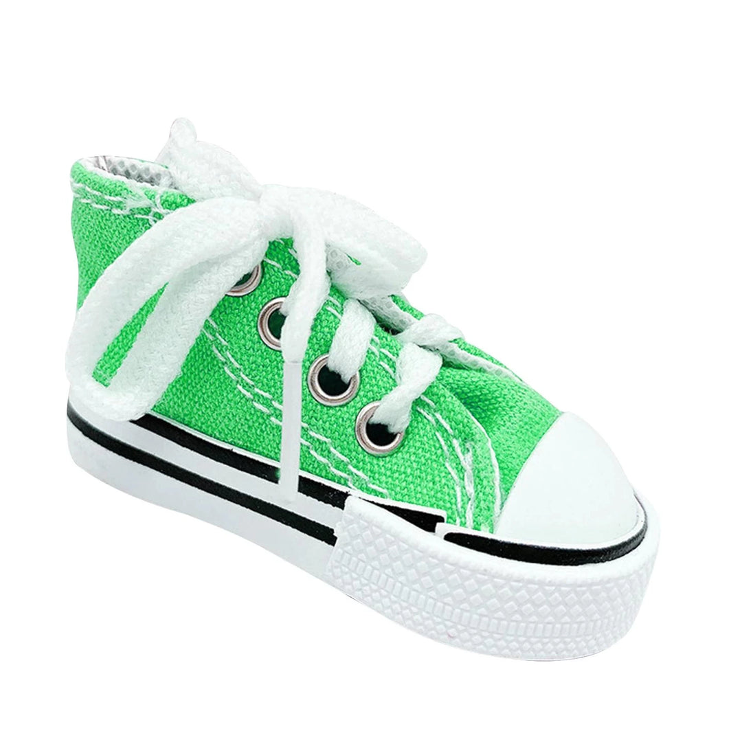 Green canvas kickstand shoe cover with white laces, side view.