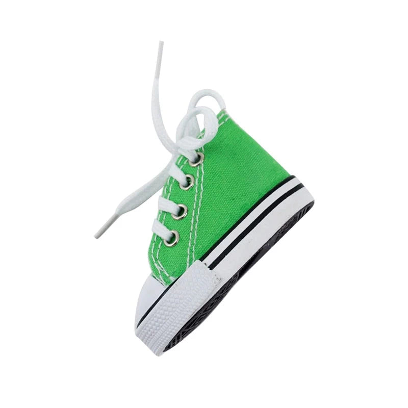 Green canvas kickstand shoe cover with white laces, side view.