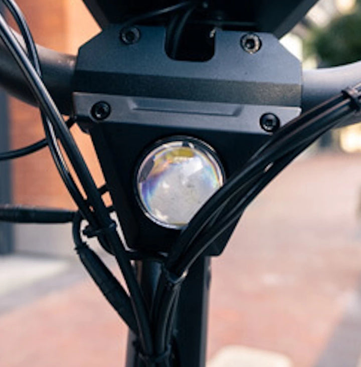 Close-up of 1000 Lumen Headlight installed on Bexly Blackhawk scooter for optimal visibility.