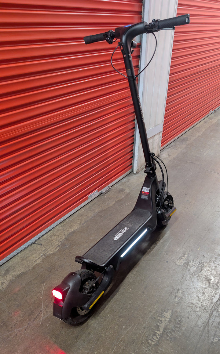 Rear angled view of the Ex-Demo Voltrium ION Max Dual motor electric scooter with side and rear lights activated