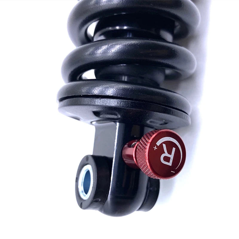 Close-up view of the adjustable KS EXA Form 291R suspension shock with red rebound adjuster for precise tuning.