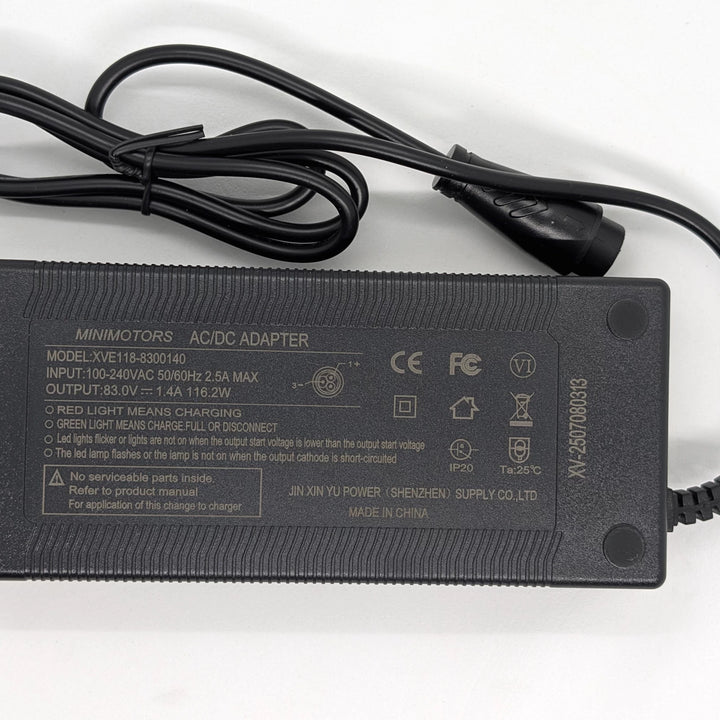 Minimotors XVE118-8300140 charger label showing 83V 1.4A 116.2W output and CE and FCC Certification.