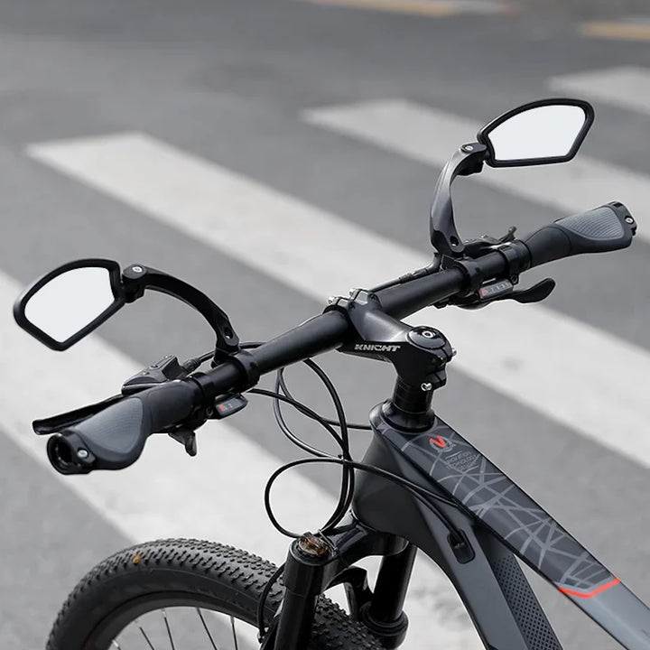 Pair of adjustable stainless mirrors on e-bike handlebars.