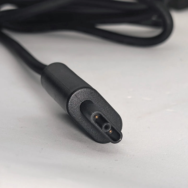 Close up view of the Segway Ninebot GT1 and GT2 flat-square charging connector, showing two pins
