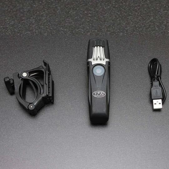 NiteRider Lumina 1000 Boost headlight with included USB charging cable and handlebar mount.