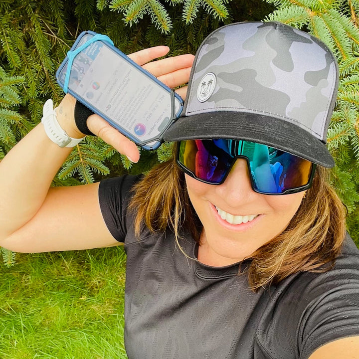 Female runner demonstrating secure fit of NoxGear Phone Holder