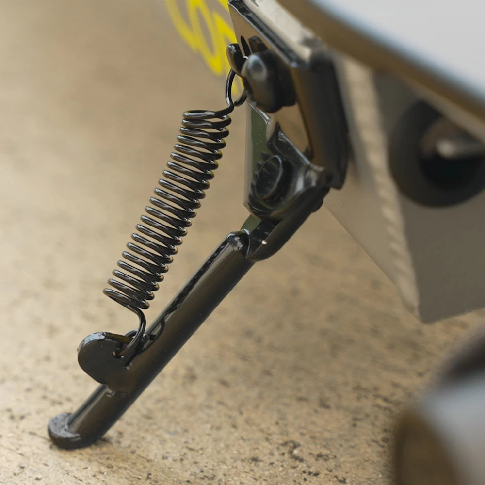 Detailed side view of Razor PowerCore Siege Electric Scooter's kickstand with a durable steel spring, supporting stability.