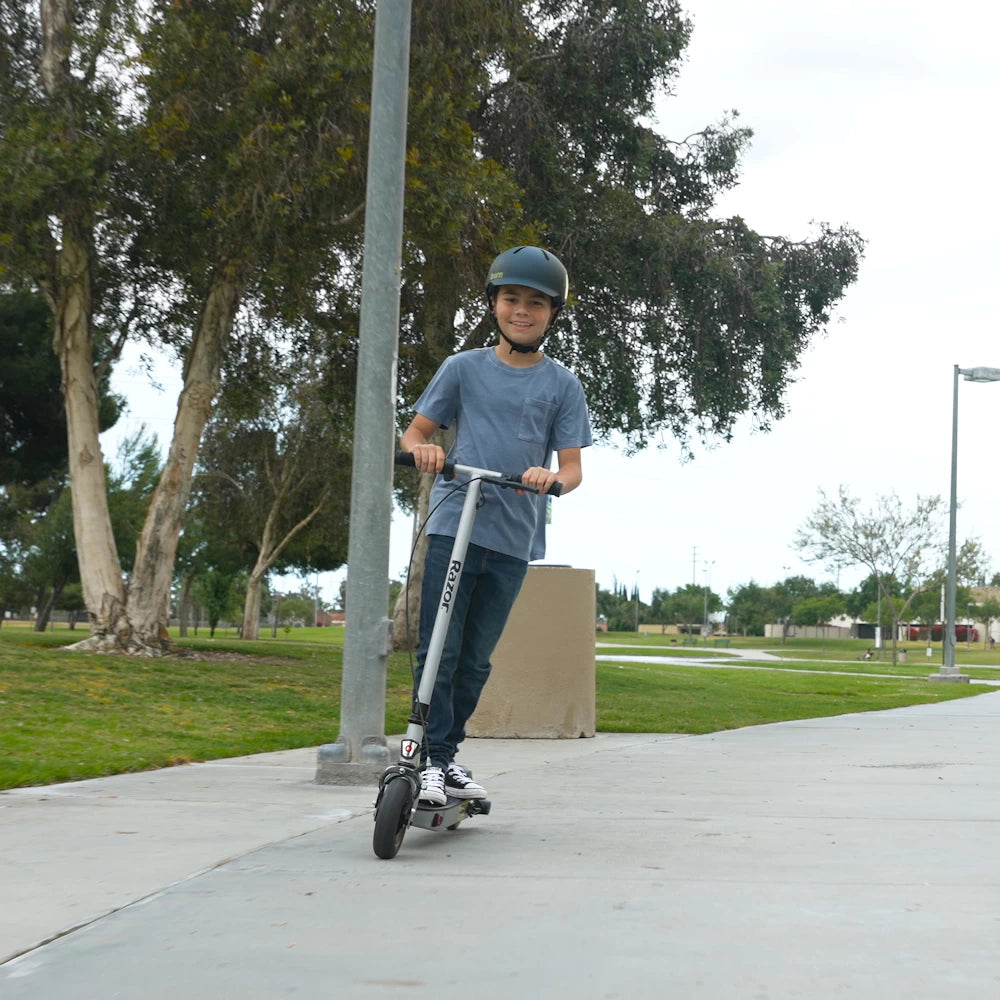 Teenager standing on the Razor PowerCore Siege Electric Scooter deck, perfect for safe riding up to 40 minutes of continuous use.